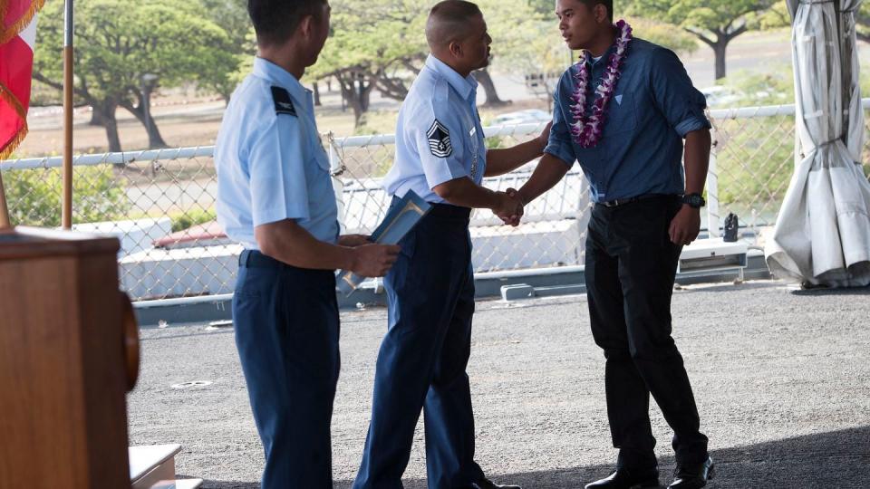 Air Force Senior Master Sgt. Christopher Perez, Recruiting and Retention superintendent, Hawaii Air National Guard, congratulates Noel Antalan, Air National Guard enlistee, during the Inaugural Our Community Salutes (OCS) Recognition Ceremony at the USS Battleship Missouri Memorial May 17, 2015, on Ford Island, Joint Base Pearl Harbor-Hickam, in Hawaii. (Staff Sgt. Christopher Hubenthal/Air Force)