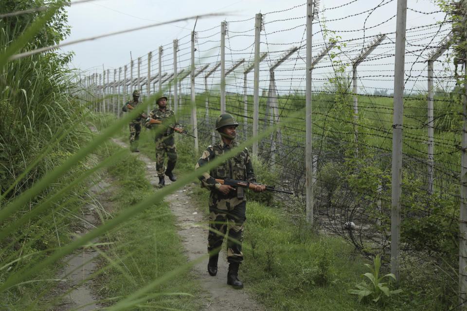 India's Border Security Force (BSF) soldiers patrol near the India Pakistan border fencing at Garkhal in Akhnoor, about 35 kilometers (22 miles) west of Jammu, India, Tuesday, Aug.13, 2019. Pakistan has denounced India’s actions to change the special status of the disputed Himalayan region of Kashmir and has downgraded its diplomatic ties with New Delhi. (AP Photo/Channi Anand)