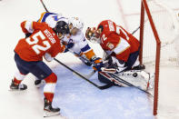 New York Islanders left wing Anders Lee (27) jostles for the puck with Florida Panthers goaltender Sergei Bobrovsky (72) as teammate MacKenzie Weegar (52) defends during first period NHL hockey action in Toronto, Friday, Aug. 7, 2020. (Chris Young/The Canadian Press via AP)