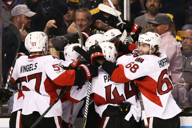 Members of the Ottawa Senators celebrate with Clarke MacArthur after he scored the game winning overtime goal to defeat the Boston Bruins on April 23, 2017