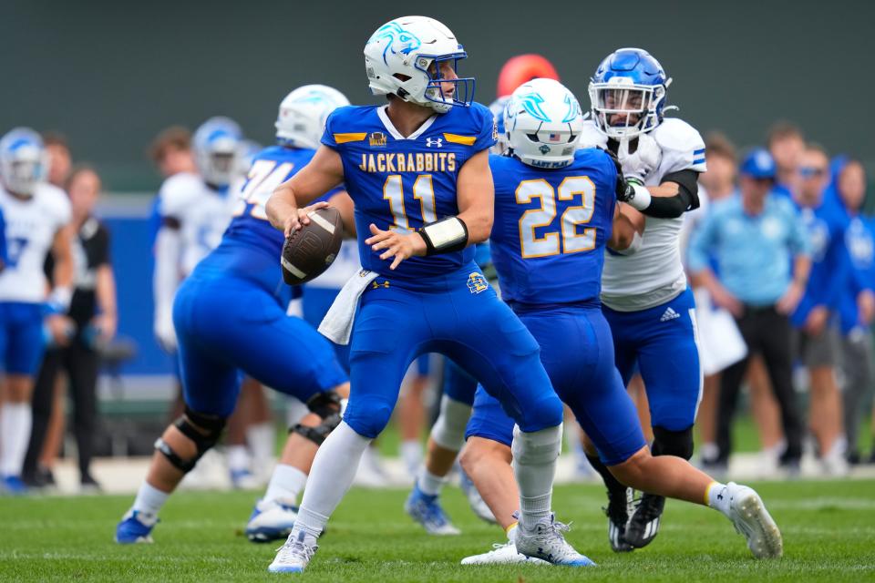 South Dakota State quarterback Mark Gronowski (11) looks to pass during the first half of an NCAA college football game against Drake, Saturday, Sept. 16, 2023, in Minneapolis. (AP Photo/Abbie Parr)