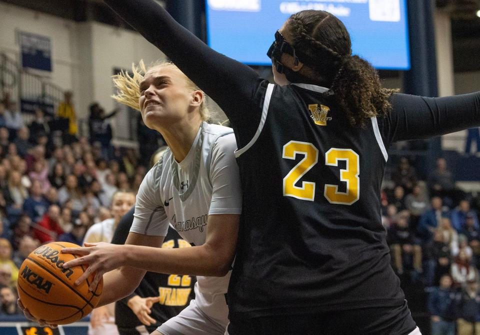 Squan’s Carlie Lapinski drives into the basket against SJV’s Stella Lockhart. Manasquan Basketball vs. St. John Vianney in Shore Conference Girls Basketball Final in West Long Branch, NJ on February 18, 2024.