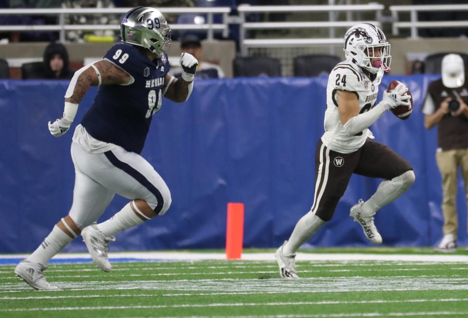 Western Michigan wide receiver Skyy Moore runs by Nevada defensive tackle Dom Peterson during the first half of the Quick Lane Bowl on Monday, Dec. 27, 2021, at Ford Field.
