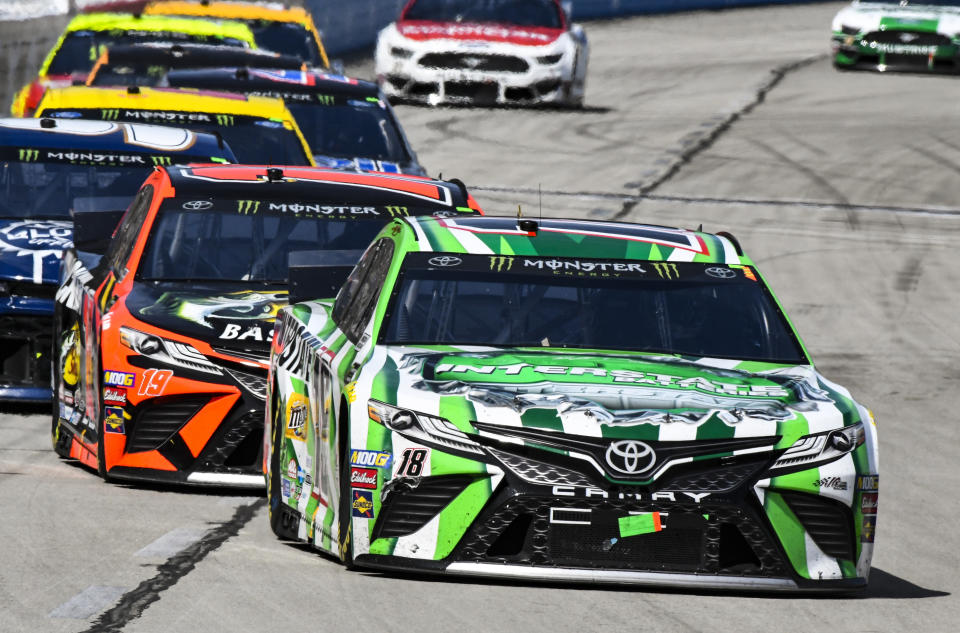 Driver Kyle Busch (18) heads into turn 1 during a NASCAR Cup auto race at Texas Motor Speedway, Sunday, March 31, 2019, in Fort Worth, Texas. (AP Photo/Larry Papke)