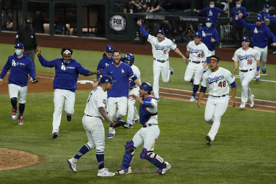 FILE - In this Oct. 27, 2020, file photo, the Los Angeles Dodgers celebrate after defeating the Tampa Bay Rays 3-1 to win the baseball World Series in Game 6 in Arlington, Texas. The Dodgers were isolated for a long time when they were last in North Texas — and won the World Series in the most unusual postseason. For the first time since those neutral-site 2020 playoffs during the pandemic, Los Angeles returns to Globe Life Field this weekend. (AP Photo/Tony Gutierrez, file)