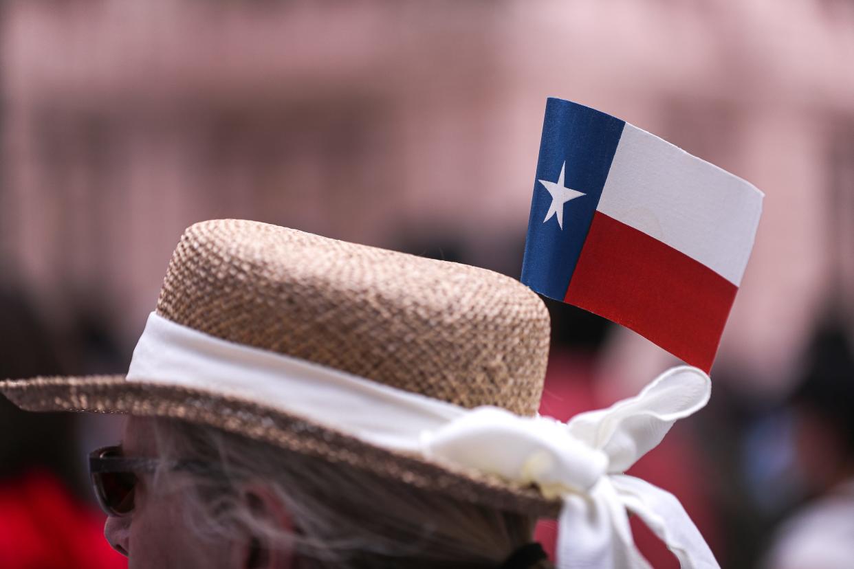 A small Texas flag sits on the hat of Carolyn Boyle. About 200 activists attended a "Let My People Vote" rally at the Texas Capitol on July 19, 2021. [AMERICAN-STATESMAN/FILE]