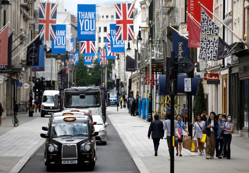 FILE PHOTO: People walk along New Bond Street, as shops re-open amid the coronavirus disease (COVID-19) outbreak, in London