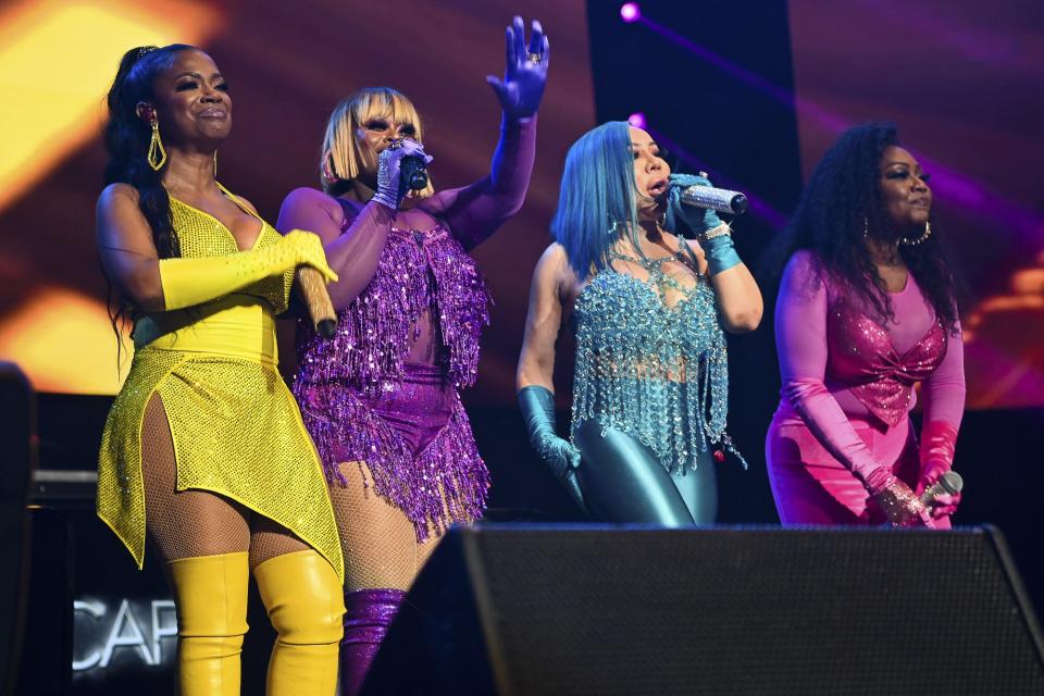 Kandi Burress, Tamika Scott, Tameka "Tiny" Harris and LaTocha Scott of Xscape performs onstage during the Strength Of A Woman Festival & Summit State Farm Arena Concert at State Farm Arena on May 07, 2022 in Atlanta, Georgia.