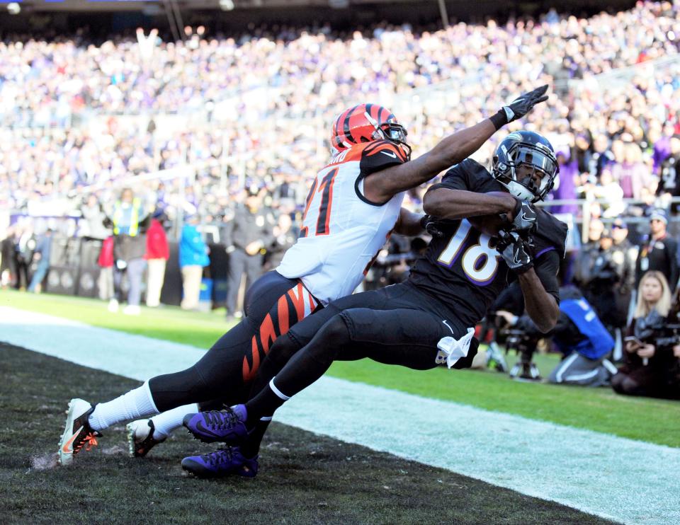 Nov 27, 2016; Baltimore, MD, USA; Baltimore Ravens wide receiver Breshad Perriman (18) catches a touchdown over Cincinnati Bengals cornerback Darqueze Dennard (21) in the first quarter at M&T Bank Stadium.