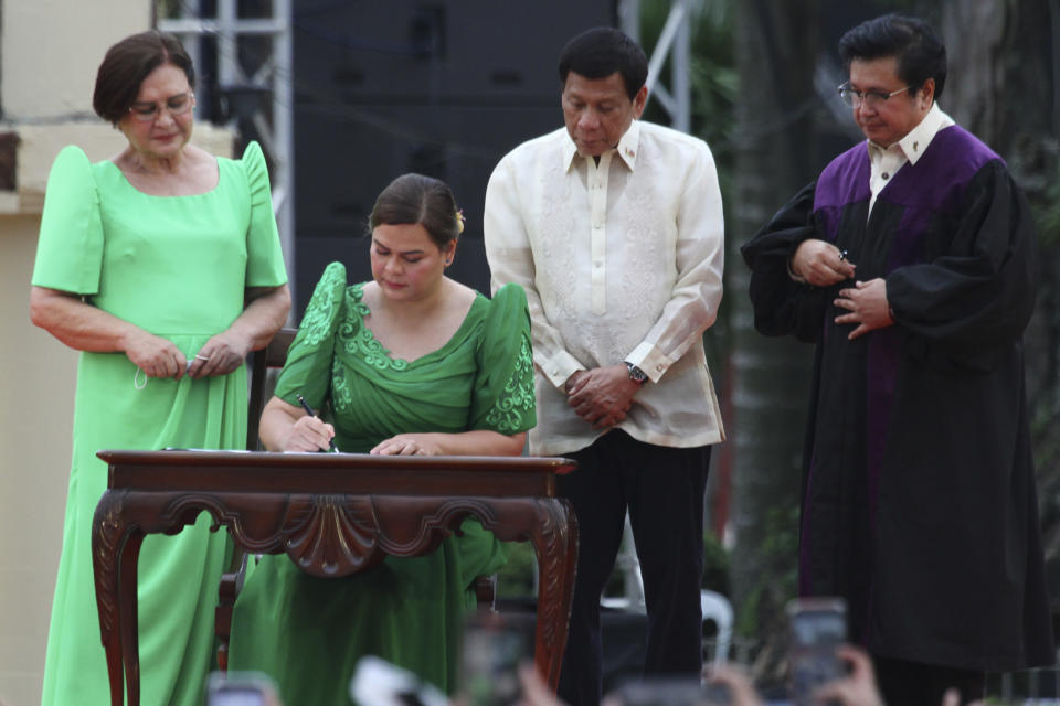 FILE - Sara Duterte, daughter of outgoing populist president of the Philippines, signs documents during her oath taking as vice president in her hometown in Davao city, southern Philippines, June 19, 2022. Sara Duterte, who resigned from her position last week, said Tuesday, June 25, 2024, that her father, former President Rodrigo Duterte, and two brothers plan to run for the Senate in mid-term elections next year. (AP Photo/Manman Dejeto, File)