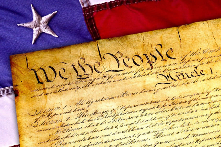  Preamble to U.S. Constitution atop American flag. 