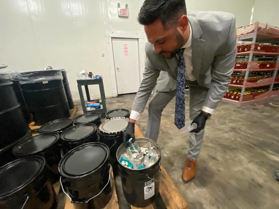 Dylan Boigris, a Coconut Grove trial attorney, inspectes samples from the 2010 BP Deepwater Horizon oil spill that are being stored in a South Florida warehouse. 