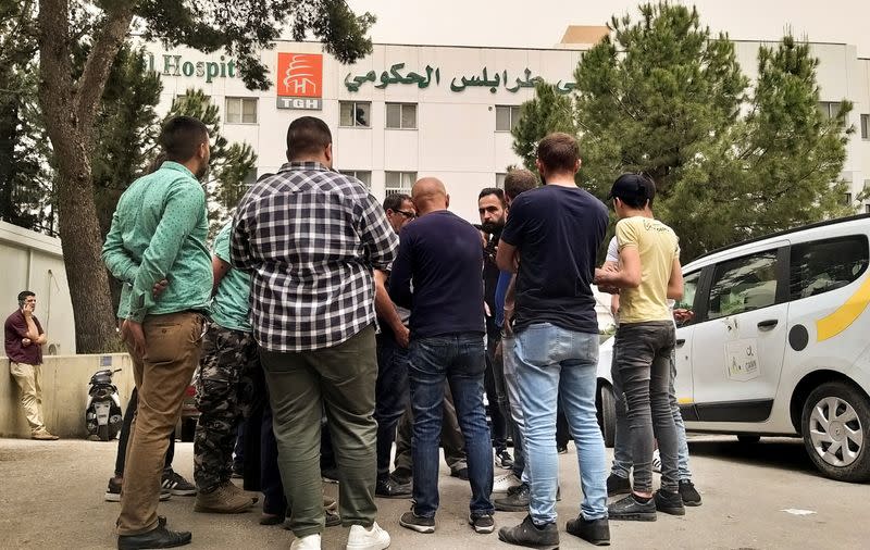 Relatives of people who died when a boat capsized off the Lebanese coast of Tripoli overnight, gather outisde a governmental hospital in Tripoli