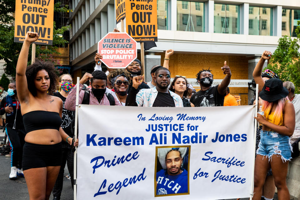 WASHINGTON, DC - AUGUST 27: Protesters raise their fists in memory of Kareem Ali Nadir Jones at Black Lives Matter Plaza on August 27, 2020 in Washington, DC. Protesters gathered on the final night of the Republican National Convention in which both President Donald Trump Vice President Mike Pence accepted the Republican nomination as candidates for a second term as U.S. President. (Photo by Natasha Moustache/Getty Images)