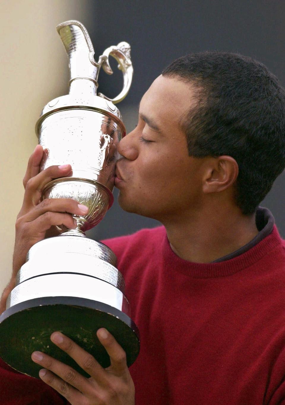 Tiger Woods kisses the trophy after winning the British Open on the Old Course at St. Andrews on July 23, 2000.