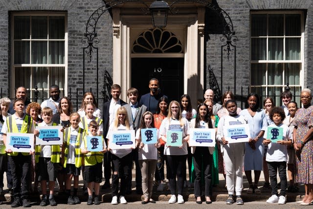 Rio Ferdinand poses for photographs with children at 10 Downing Street to celebrate the launch of the Diana Award’s annual anti-bullying campaign Don’t Face It Alone (Stefan Rousseau/PA)