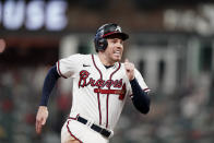 Atlanta Braves' Freddie Freeman (5) runs to third base after a Atlanta Braves' Ozzie Albies single against the Milwaukee Brewers during the sixth inning of Game 4 of a baseball National League Division Series, Tuesday, Oct. 12, 2021, in Atlanta. (AP Photo/Brynn Anderson)