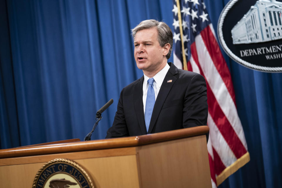 FBI Director Christopher Wray speaks during a virtual news conference at the Department of Justice, Wednesday, Oct. 28, 2020 in Washington. The Justice Department has charged eight people with working on behalf of the Chinese government to locate Chinese dissidents and political opponents living in the U.S. and coerce them into returning to China. Five of the eight were arrested Wednesday morning. (Sarah Silbiger/Pool via AP)