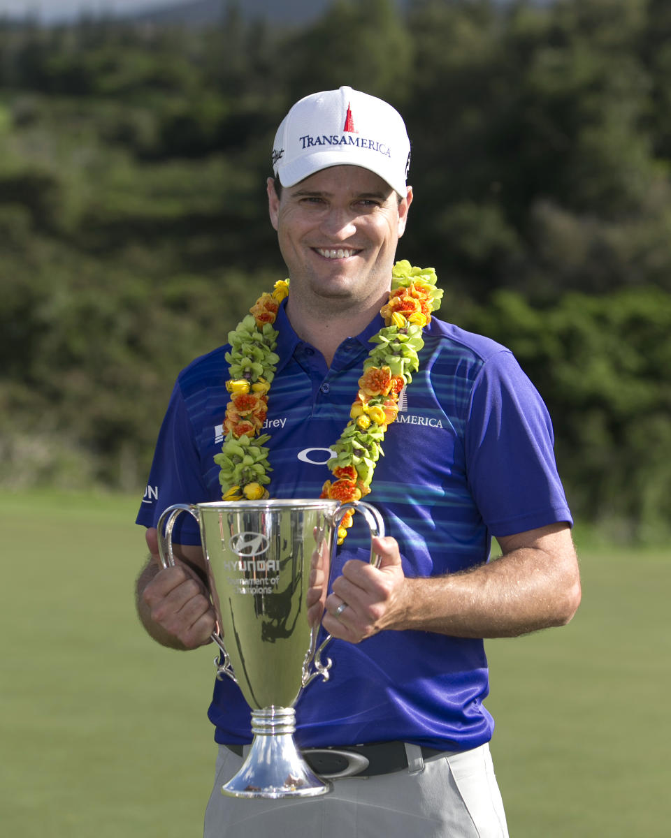 Zach Johnson holds the trophy after winning the Tournament of Champions golf tournament, Monday, Jan. 6, 2014, in Kapalua, Hawaii. Johnson pulled away with three straight birdies on the back nine at Kapalua and closed with a 7-under 66 for a one-shot victory over Jordan Spieth on Monday. (AP Photo/Marco Garcia)