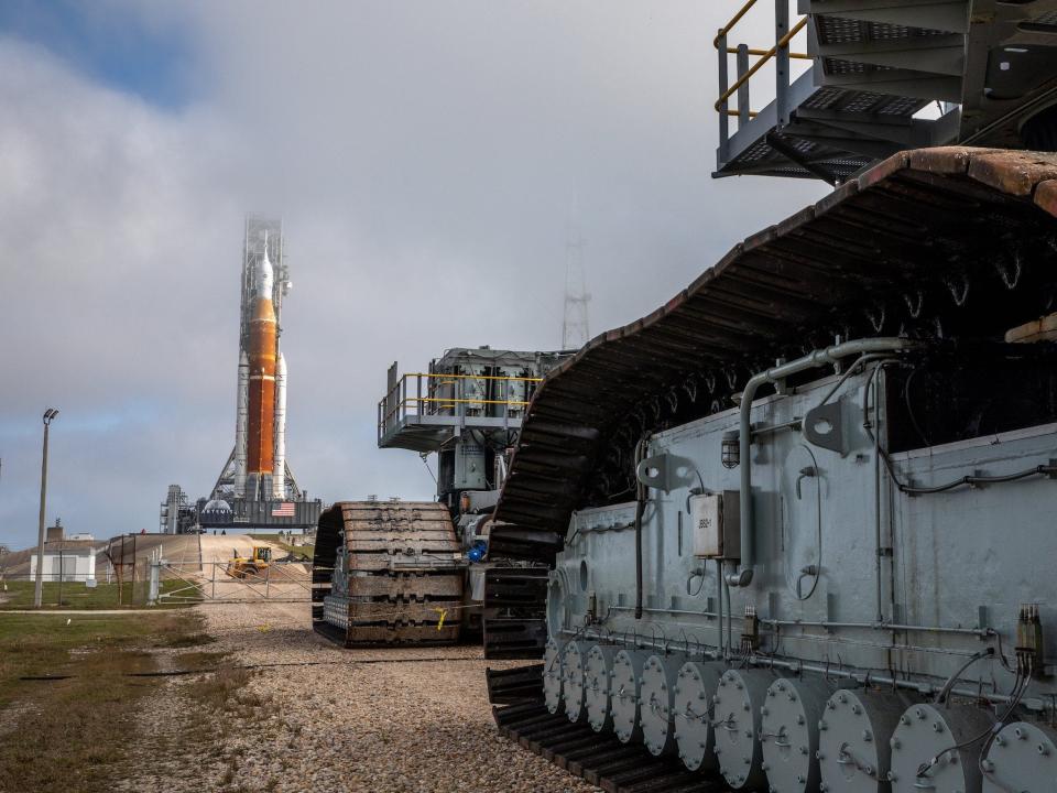 large crawling machines with belt wheels with sls rocket in the background