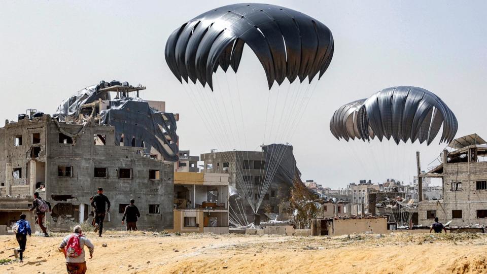 PHOTO: People rush to landing humanitarian aid packages dropped over the northern Gaza Strip, Apr. 23, 2024. (-/AFP via Getty Images)