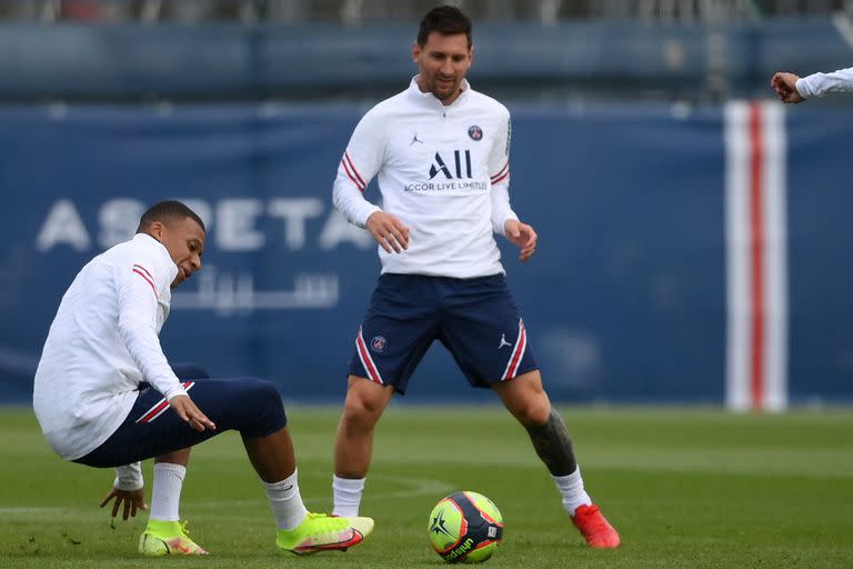 El delantero francés del Paris Saint-Germain Kylian Mbappé  y el delantero argentino del Paris Saint-Germain Lionel Messi participan en una sesión de entrenamiento en el campo de entrenamiento del club de fútbol Camp des Loges Paris Saint-Germain