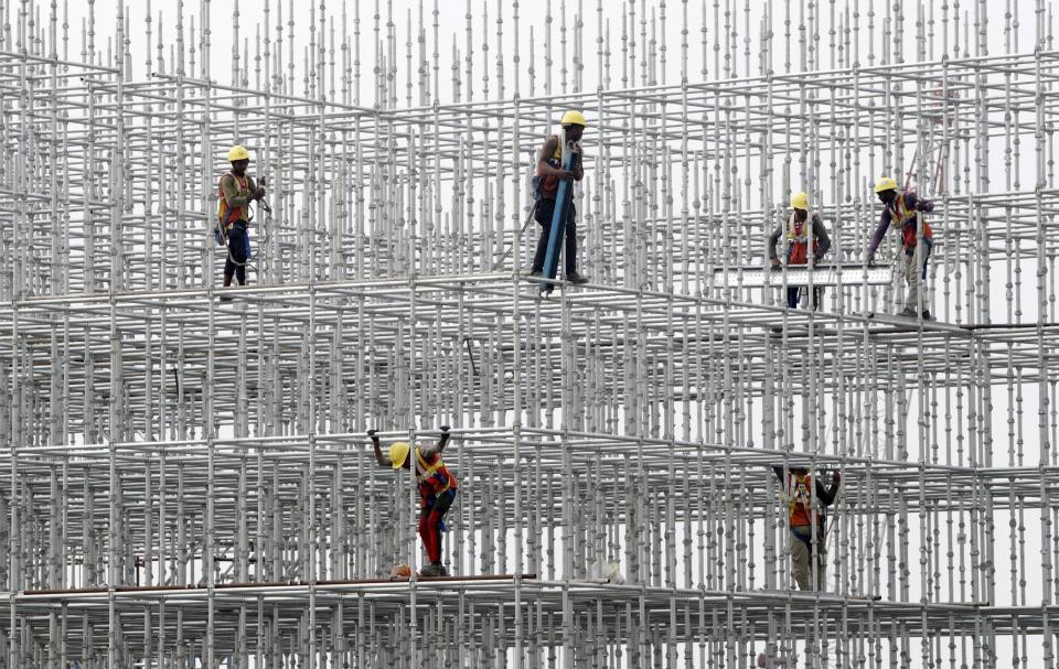 FILE - Construction workers prepare a scaffolding at a construction site at Hajji Ali in Mumbai, India, on Jan. 8, 2022. The Asian Development Bank has downgraded its forecasts for growth in the region, citing the war in Ukraine, rising interest rates aimed at fighting decades-high inflation and China's slowing economy. (AP Photo/Rajanish kakade, File)