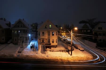 Lights mark the paths of vehicles through a winter snow storm in Medford, Massachusetts, U.S. February 12, 2017. REUTERS/Brian Snyder