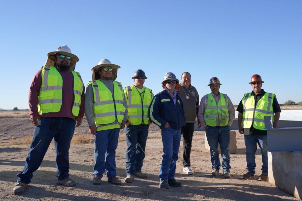 Governor Lewis stands with several people in hard hats and high-visibility vests at the 8 December ground-breaking ceremony. (Gila River Indian Community)