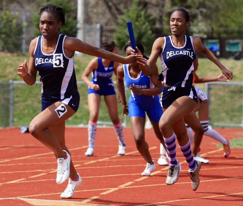 Delcastle's Celina Emerson (left) starts heading for the finish line before taking the final exchange from Javonna Dickerson as their team wins the 4x100 during the Diamond State Relays, Saturday, April 3, 2010 at A.I. duPont High School.