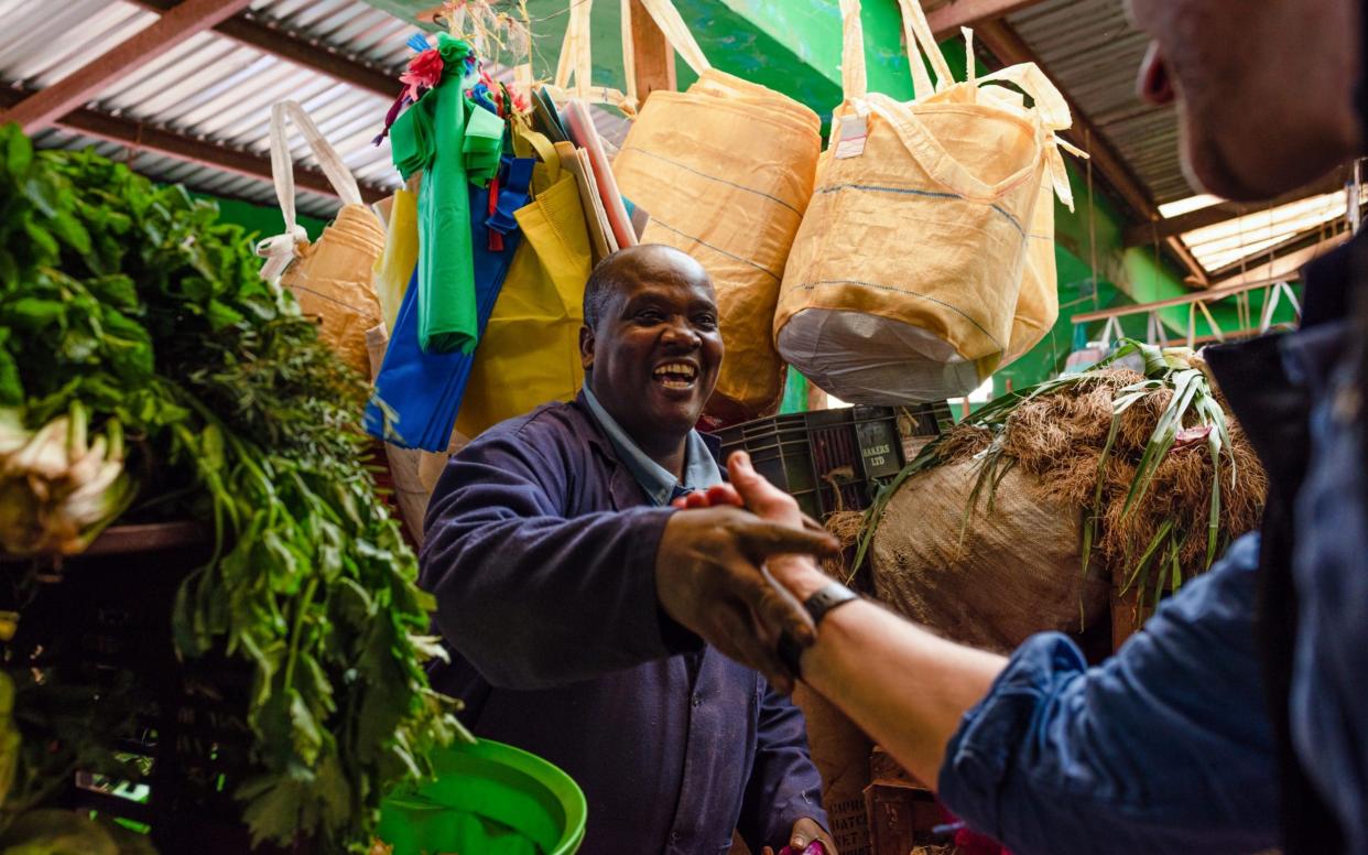 Wangige market trader Geoffrey Kamanu shakes the hand of Wayne Hennessy-Barrett - Katie G. Nelson, The Telegraph