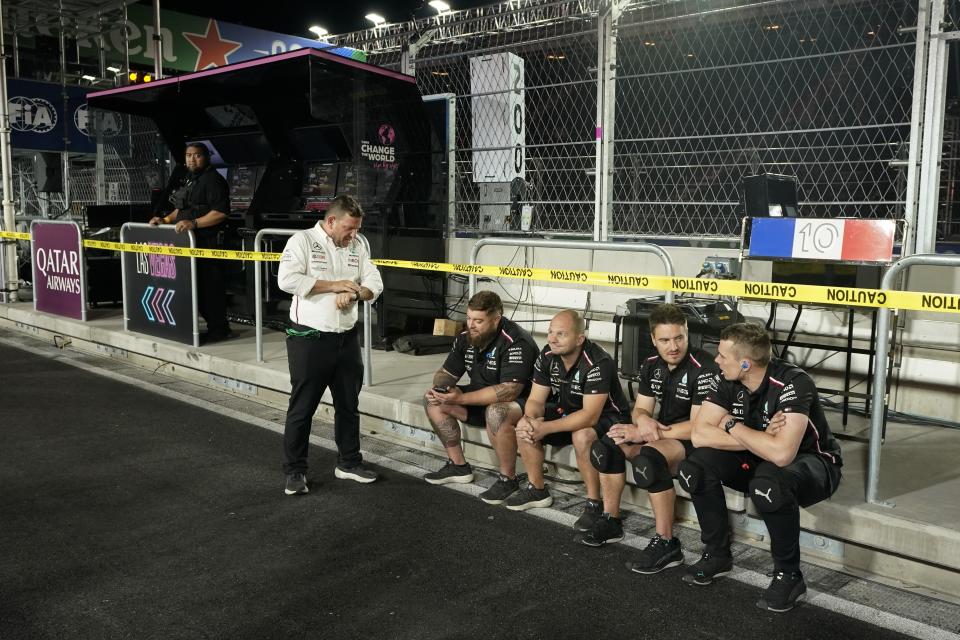 Mercedes crew members wait for the start of the second practice session for the Formula One Las Vegas Grand Prix auto race, Friday, Nov. 17, 2023, in Las Vegas. (AP Photo/Darron Cummings)