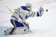 Buffalo Sabres goaltender Linus Ullmark (35) reaches for the puck during a shootout of an NHL hockey game against the Washington Capitals, Sunday, Jan. 24, 2021, in Washington. (AP Photo/Nick Wass)