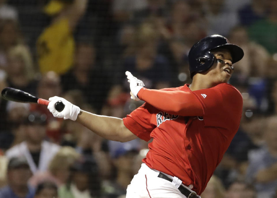 Boston Red Sox's Rafael Devers watches his RBI double during the sixth inning against the Los Angeles Dodgers in a baseball game at Fenway Park, Friday, July 12, 2019, in Boston. (AP Photo/Elise Amendola)