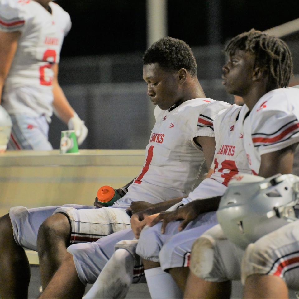 Seminole Ridge’s Ty Jackson appears to contemplate the game on the sideline during Friday’s preseason matchup against Martin County (Aug. 18, 2023).