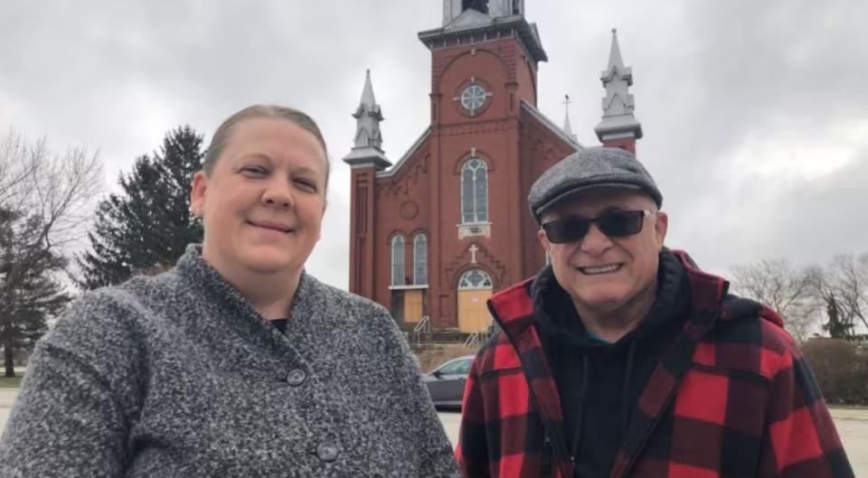 Marcie Glajch and David Tremblay stand in front of the Annunciation Church before demolition last year.