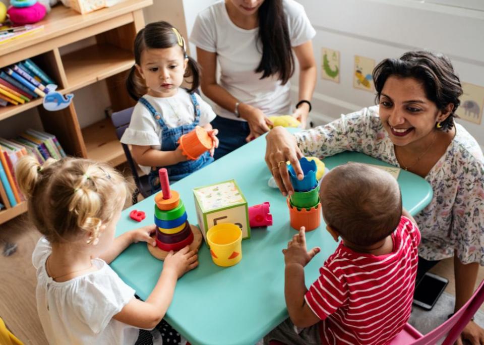 Preschool teacher in the classroom with children.