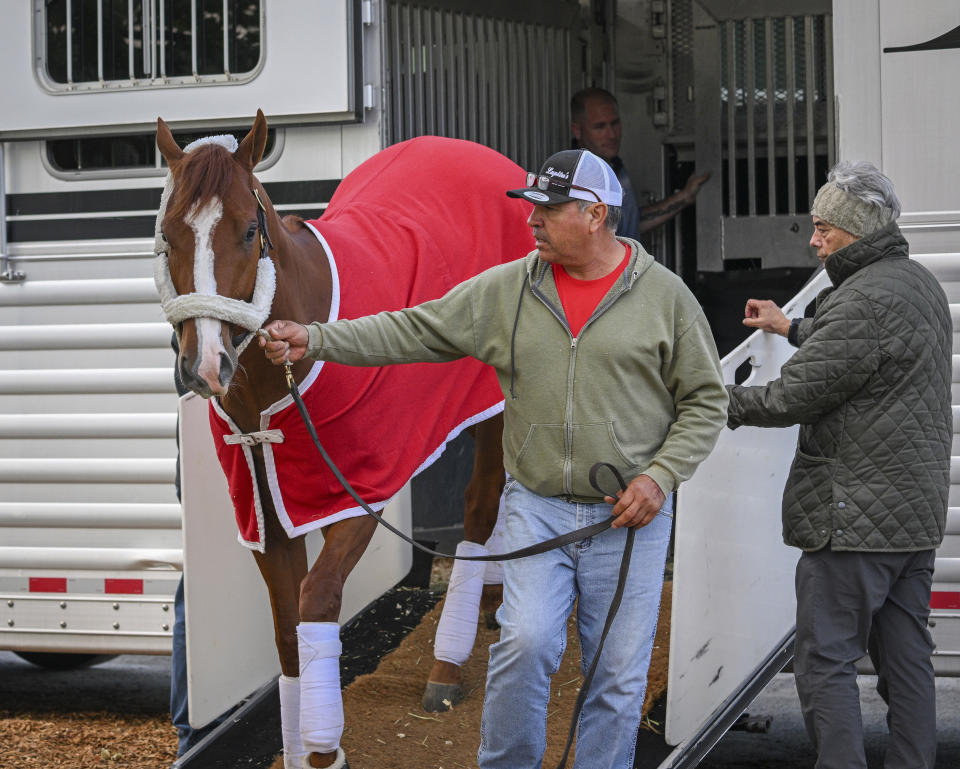 Kentucky Derby winner Mage arrives at Pimlico Race Course early Sunday, May 14, 2023 to prepare for this weekend's Preakness Stakes as trainer Gustavo Delgado, Sr., right, looks on. (Jerry Jackson/The Baltimore Sun via AP)