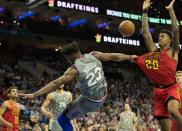 Jan 11, 2019; Philadelphia, PA, USA; Philadelphia 76ers guard Jimmy Butler (23) grabs the jersey of Atlanta Hawks forward John Collins (20) while falling after being fouled during the fourth quarter at Wells Fargo Center. Mandatory Credit: Bill Streicher-USA TODAY Sports