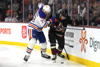 Edmonton Oilers defenseman Vincent Desharnais (73) and Arizona Coyotes center Klim Kostin battle for the puck in the second period during an NHL hockey game, Monday, March 27, 2023, in Tempe, Ariz. (AP Photo/Rick Scuteri)