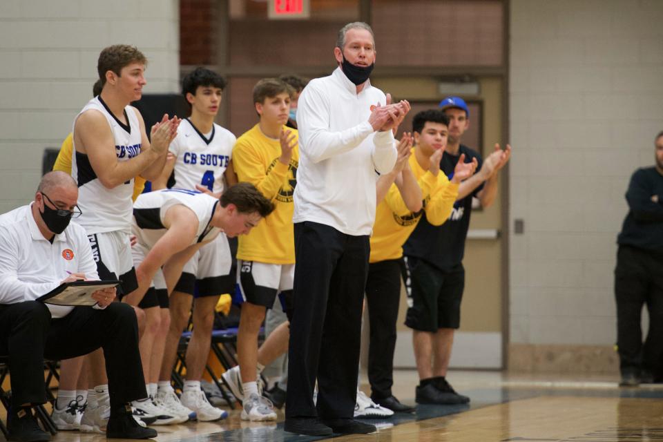 Former Central Bucks South head coach Jason Campbell applauds after the Titans got a defensive stop against Pennsbury in a January 2022 game.