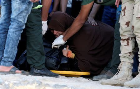 An Egyptian mother reacts beside the body of her son who was on a boat carrying migrants which capsized off Egypt's coast, in Al-Beheira, Egypt, September 22, 2016. REUTERS/Mohamed Abd El Ghany