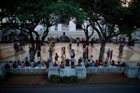 People dance tango during a weekly Sunday milonga on Havana's Paseo del Prado promenade