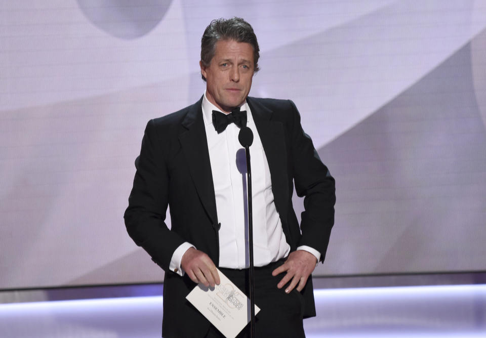 Hugh Grant presents the award for outstanding performance by an ensemble in a drama series at the 25th annual Screen Actors Guild Awards at the Shrine Auditorium &amp; Expo Hall on Sunday, Jan. 27, 2019, in Los Angeles. (Photo by Richard Shotwell/Invision/AP)
