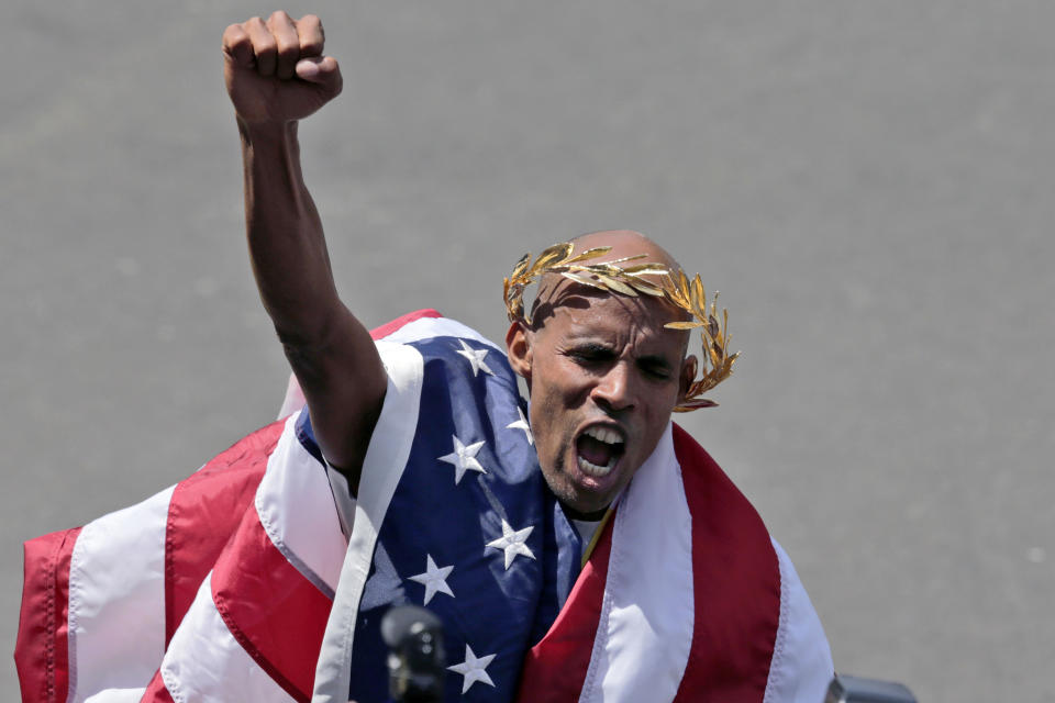 FILE — Meb Keflezighi, of San Diego, celebrates his victory in the 118th Boston Marathon, April 21, 2014, in Boston. A four-time Olympian, Keflezighi was just a spectator in Boston in 2013, taking notes on what he saw. He left the finish line about five minutes before the bombs exploded. "I remember vividly saying, 'I hope to be healthy enough to win it for the people next year,'" he said. "I felt blessed that God gave me the opportunity to rise to the occasion." (AP Photo/Charles Krupa, File)