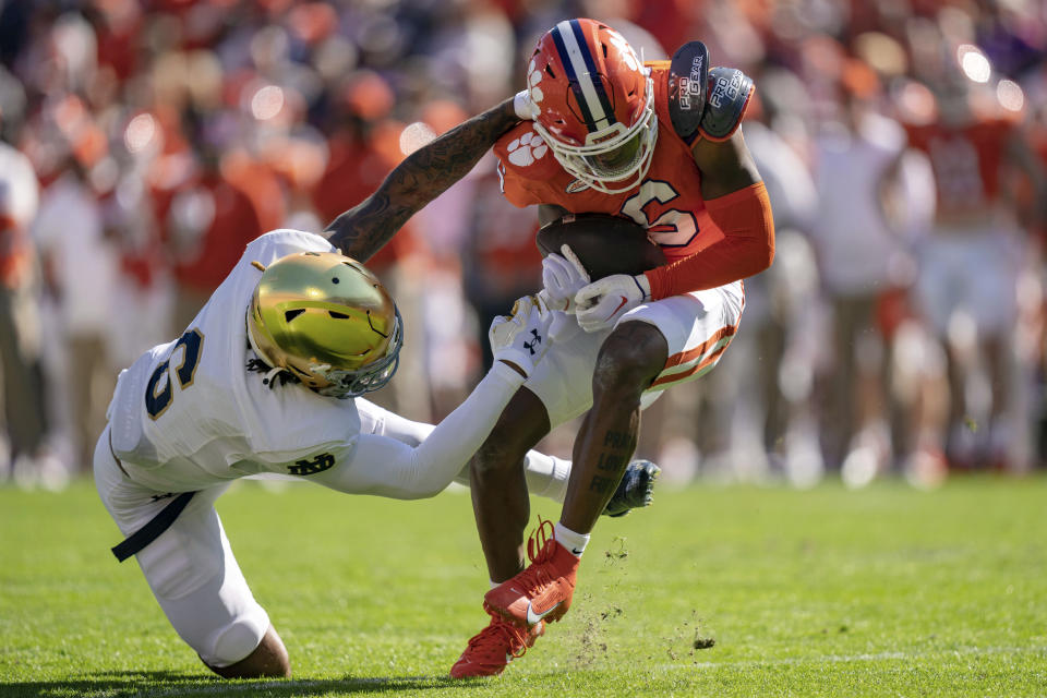 Clemson wide receiver Tyler Brown (6) escapes a tackle from Notre Dame cornerback Clarence Lewis (6) during the first half of an NCAA college football game Saturday, Nov. 4, 2023, in Clemson, S.C. (AP Photo/Jacob Kupferman)