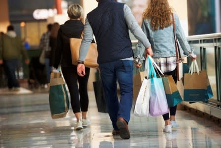 Shoppers carry bags of purchased merchandise at the King of Prussia Mall, United States' largest retail shopping space, in King of Prussia