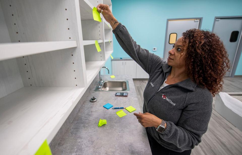 Director of Operations for VetCheck franchise Jeanné Gentry labels shelves for supplies  on Thursday, June 1, 2023, to help prepare for the clinic's opening.