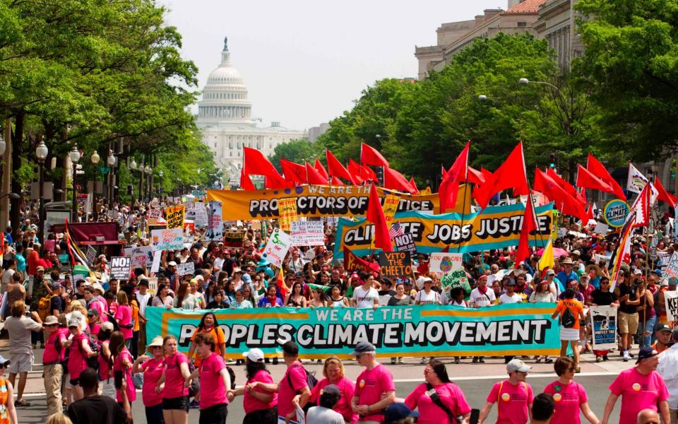 Demonstrators march on Pennsylvania Avenue during the People's Climate March in Washington DC - AFP