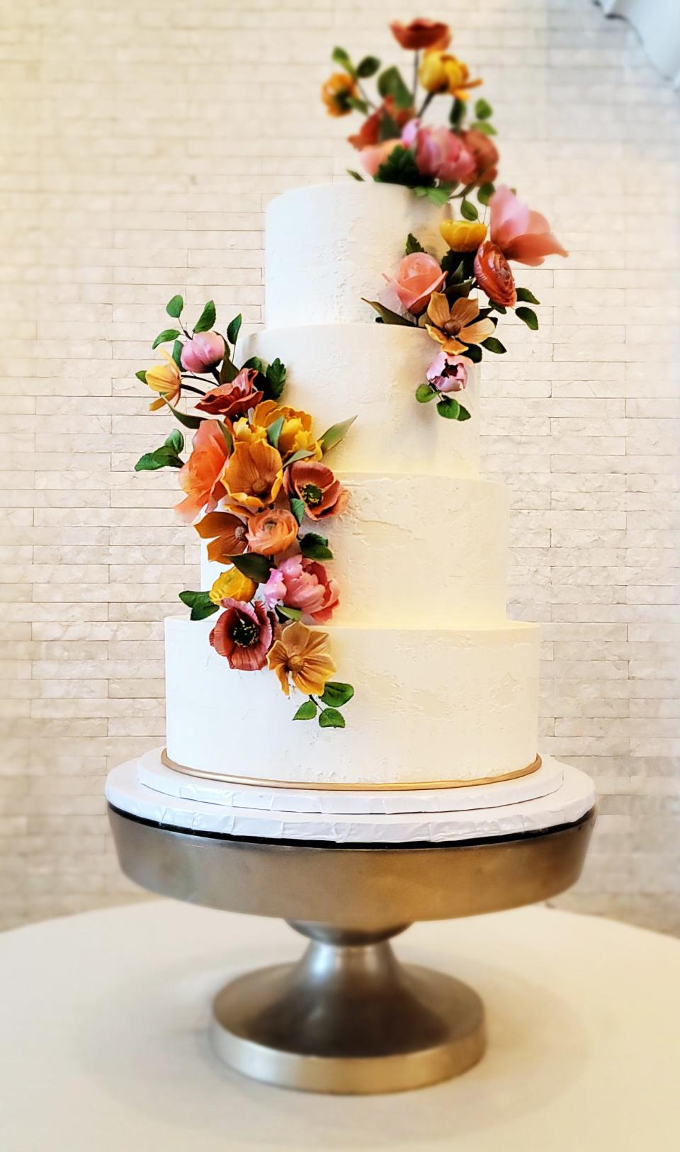 A recent wedding cake creation from Confectionary Designs in Rehoboth. All the flowers on their cakes are hand crafted with sugar.